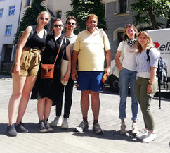 Riga free walking tour guide Philip Birzulis with a group of five smiling tourists