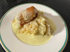Teller mit Hühnchen auf Champagner-Chilikraut mit Curryschaum