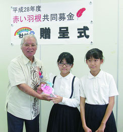 富野小中学校児童会から那根会長へ募金が贈呈された=18日、市社協(石垣市共同募金委員会提供写真)