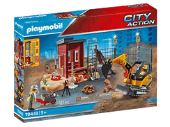 Minibagger mit Baugrube und Bauarbeiter.