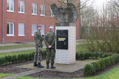 Oberstabsfeldwebel Axel Hammers erläutert Brigadegeneral Michael Matz die Gedenksteine des Verbandes