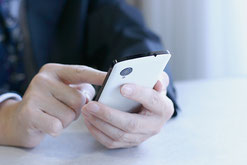 名刺を見てスマホでネットにつなぎ確認