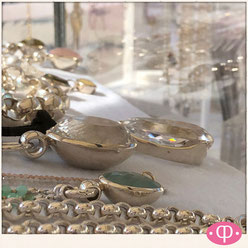Einblick in die Perlenpool Schmuckvitrine mit 925 Silber Halsketten mit großen Mineralsteinanhängern. 