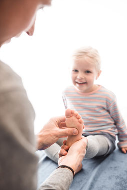 Osteopath Sören Gnoss bei der parietalen Behandlung eines Kindes am Fuß – sanfte und gezielte osteopathische Techniken zur Förderung der kindlichen Gesundheit. Individuelle Therapieansätze für eine ganzheitliche Unterstützung des Bewegungsapparats