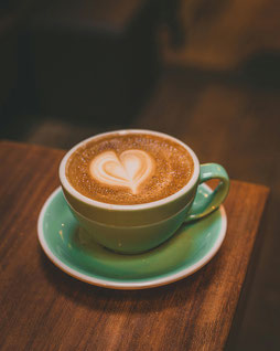 Cup of coffee with a heart as a symbol of self-care.