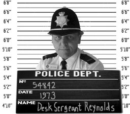 Mugshot-style photo of dodgy policeman Desk Sargeant Reynolds