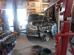 Mechanic replacing a 2012 Chevy Cruz Engine