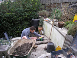 Connecting the French drains through a retaining wall to a dispersal outlet