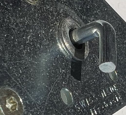 Metal picture hanger with angle screw added