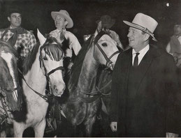 During the filming of his scenes for "The Longest Day" in the Paris studios, John Wayne receives a cowboy reception. 