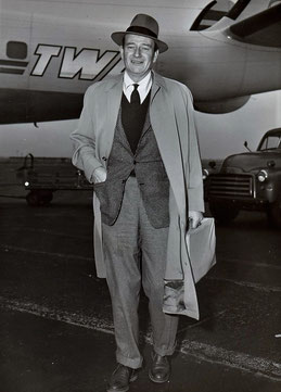 John Wayne takes a TWA flight from Paris to Chicago. 