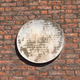Illegible plaque.