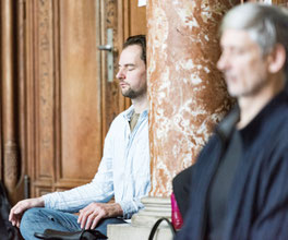 Two men absorbed in meditation.