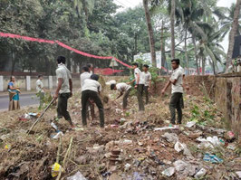 Children clearing garbage scattered land after the flood disaster and trying to plant trees and vegetables