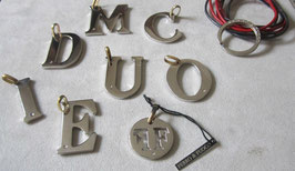 Letters pendants in steel with a small diamond