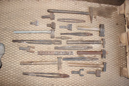 # set of blacksmith tongs , hardys , etc as on fotos