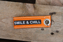 Schlüsselanhänger, schwarz/orange, "smile & chill"