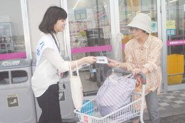 結核予防の啓発用ティッシュなどを配布する八重山保健所職員=29日午後、サンエー石垣シティ前