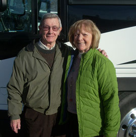 Two passengers pose by the coach