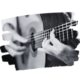 Eine Person spielt leidenschaftlich eine klassische Gitarre und bringt so musikalische Magie zum Leben.