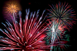 Celebration fireworks filling the night sky in an array of different colours