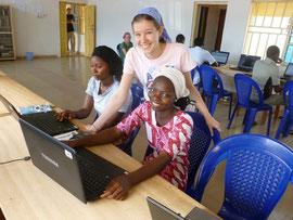 Hannah helping the students in the computer class