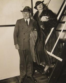 Irene Dunne and her husband, Dr.Francis Griffin, in New York. Their first trip together in four years. Irene says news pictures don't do Frank justice.