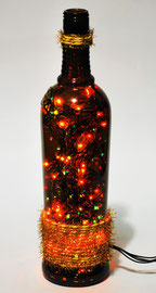 LDN - visione frontale accesa - lampada natalizia in vetro ambrato con luci a led multicolore e decorazione dorata