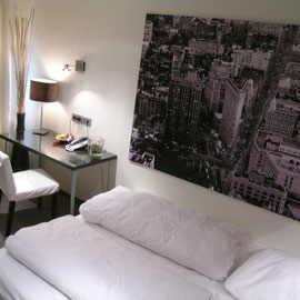 Nachher: modernisiertes Hotelzimmer mit neuem Bett, Schreibtisch und Accessoires