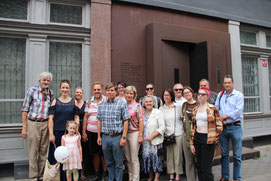 Tour guide Philip Birzulis with 20 guests outside Riga's former KGB headquarters