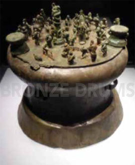Fig. 5. Cowrie shell container with drums atop. H 55 cm (Warring States Kunming City Museum) Figurines H 10 cm.