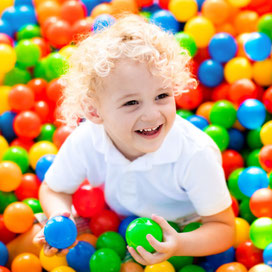 Child in ball pitt sensory therapy