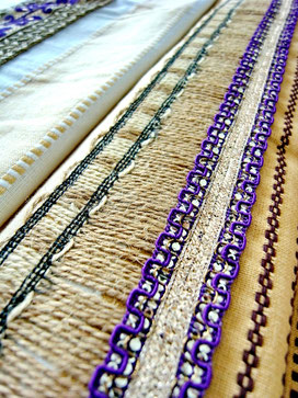 Close-up of jute trim and purple/silver ribbon, joining pieces of Indian cotton throw