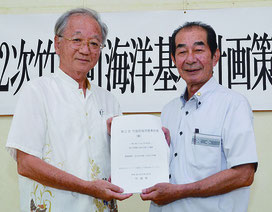 土屋委員長(左)が西大舛町長に計画案を答申した=25日、竹富町役場