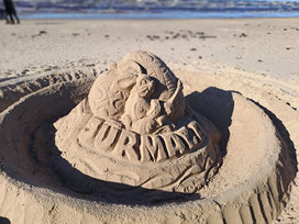 Sand sculpture on Jurmala beach of an Easter  Bunny holding a paint brush and some Easter eggs 