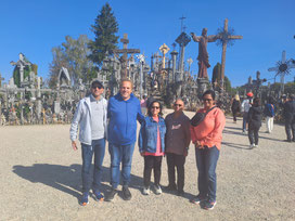 Tour guide Philip Birzulis with four tourists from India at Hill of Crosses in Lithuania