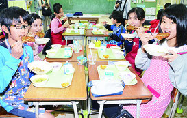 特製かき揚げを食べる児童たち=10日、石垣小学校