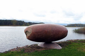 Red granite, egg-shaped sculpture by Pauls Jaunzems by the Buļļupe River in Vakarbuļļi village near Riga.