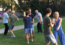 Taiji group doing partner exercises (Pushing Hands, Tuishou) at an outdoor training.