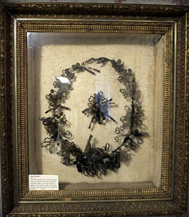 This hair wreath memorial (1978.07.01) was made of hair collected from various family members after a 16-year-old girl’s death.      c. 1882