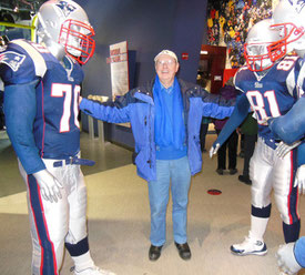 A Passenger in a Huddle with a Group of Patriots