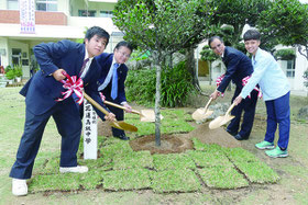 八商工の真栄田校長、花蓮高級中学校の詹滿福校長らが記念植樹を行った=25日午後、八商工