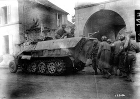 A german is about to get medical care after having been transported by a captured SdKfz 251 to Avenue Gambetta in Fel, adjacent to Chambois. August 1944.