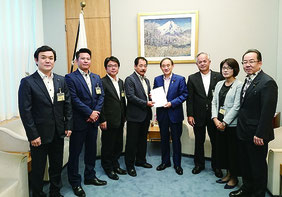 菅官房長官に要請書を提出する市議会の要請団(石垣市議会提供)