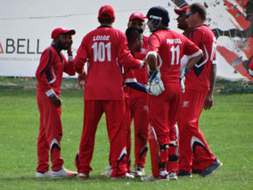 WCC fielding team come together at the fall of a wicket