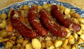 cooked sauerkraut with onions, carrots, sausages and roast potatoes