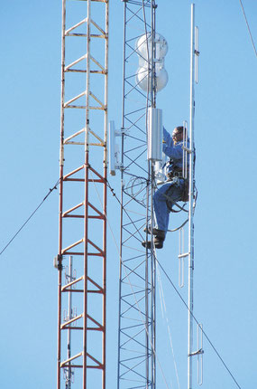 SKY IS THE LIMIT: Bellevue Munipal Utility worker Brett Ploessl climbs up 100 feet overlooking the city to install the new wireless broadband system. 