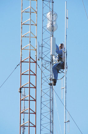 SKY IS THE LIMIT: Bellevue Munipal Utility worker Brett Ploessl climbs up 100 feet overlooking the city to install the new wireless broadband system. 