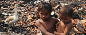 An young Indian slum dweller looks on standing near gutted shanties in the Santoshpur area on the outskirts of Kolkata on March 16, 2013. (DIBYANGSHU SARKAR/AFP/Getty Images) | Getty Images