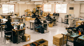 Japanese artisans manufacturing ETUBY laptop bags with precision craftsmanship